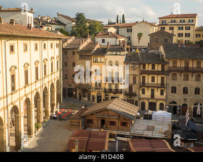 Medieval Piazza Grande, main town square in the city of Arezzo, Tuscany, Italy, with the wooden christmas market stalls. Stock Photo
