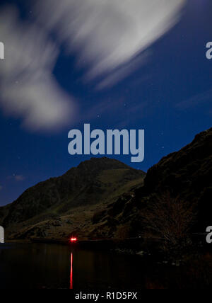 Tryfan mountain at night with traffic trail, Snowdonia, North Wales Stock Photo