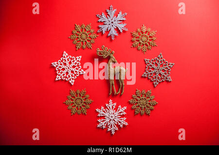 Red Christmas and New Year background with deer in circle of snowflakes. Holiday symbol Stock Photo