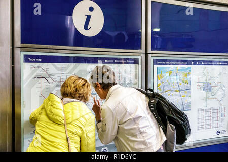 London England,UK,South Bank,Southwark Underground Station train Tube tube subway Jubilee Line,map,route,woman female women,looking,information,UK GB Stock Photo