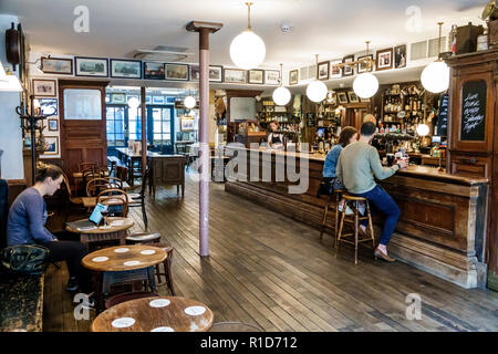 London England,UK,South Bank Southwark,Union Street,Mc & Sons Pub,traditional old Irish boozer,public house bar,worn out wood bench tables,hardwood fl Stock Photo