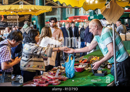 London England,UK,South Bank Southwark,Borough Market,vendors stalls,produce,fruits vegetables,Asian woman female women,man men male,shopping shopper Stock Photo