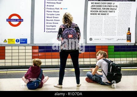 London England,UK,Soho,Piccadilly Circus Underground Station train Tube,subway tube,platform,woman female women,boy boys,male kid kids child children Stock Photo