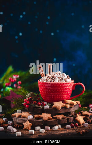 Christmas hot chocolate with marshmallows, chocolate crumbs, and syrup. Large coffee cup with homemade cocoa. Winter drink photography on a dark backg