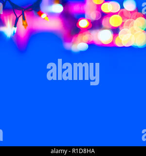 Decorative Colorful Blurred Christmas Lights On Blue Background. Abstract Soft Lights. Colorful Bright Circles Of A Sparkling Garland Stock Photo