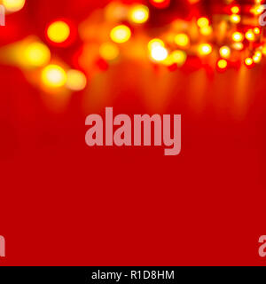 Decorative Colorful Blurred Christmas Lights On Red Background. Abstract Soft Lights. Colorful Bright Circles Of A Sparkling Garland Stock Photo