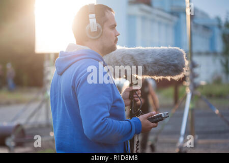 SAINT PETERSBURG, RUSSIA - OCTOBER 31, 2018: Film Crew On Location. Sound recording on the set. Man with a microphone with windproof Stock Photo