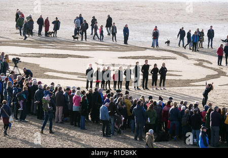 Newquay, Cornwall, UK. 11th Nov 2018. Pages of the sea WW1 commemoration event by Danny Boyle.Beach sand portrait of Seaman Archie Jewell 28 yrs died 17-04-1917, Dance by Hall for Cornwall youth, WW1 War centenary Art commissions, 11th November 2018, Robert Taylor/Alamy Live News.  Perranporth Beach, Cornwall, UK. Credit: Robert Taylor/Alamy Live News Stock Photo