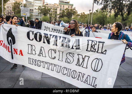 Barcelona, Catalonia, Spain. 11th Nov, 2018. A woman with a megaphone is seen behind a banner during the demonstration.A new manifestation against institutional racism has crossed the streets of the center of Barcelona. Accompanied by social organizations and the Trade Union of street vendors, more than 500 people have claimed to end racism in Barcelona and have denounced police identifications according to the color of their skin. Credit: Paco Freire/SOPA Images/ZUMA Wire/Alamy Live News