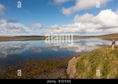 White clouds reflecting in water, Sandsound Voe, Shetland Stock Photo