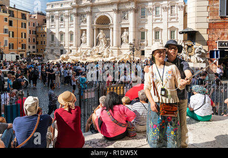 Tourists taking a selfie photograph in front of the Trevi Fountain,  Rome, Italy. Stock Photo