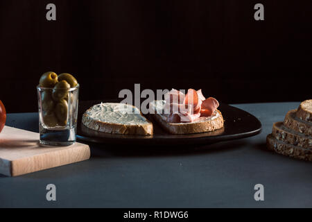 Sandwich with mortadela and tomato and olives Stock Photo