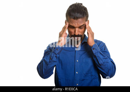 Young Indian businessman having headache studio portrait against white background Stock Photo