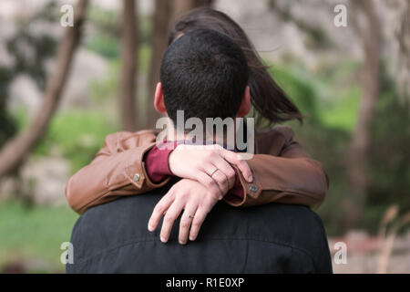 Engagement Photos, rings visible on the hands in the nature. focused rings. blurred background. love story Stock Photo
