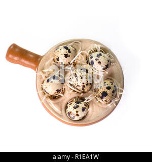 over head shot of six quail eggs close up shot isolated on a white background Stock Photo