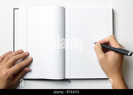 Empty note book with man hands hold a pen Stock Photo