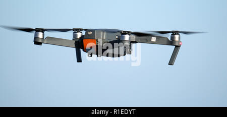 Camera carrying remote control drone in flight. Stock Photo
