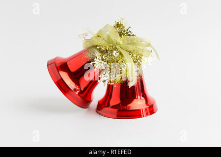 Christmas and new year red bells with gold tinsel on white background Stock Photo