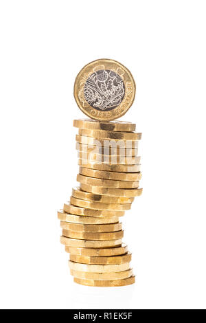 UK British Pound coin on top of stack of coins with white background Stock Photo