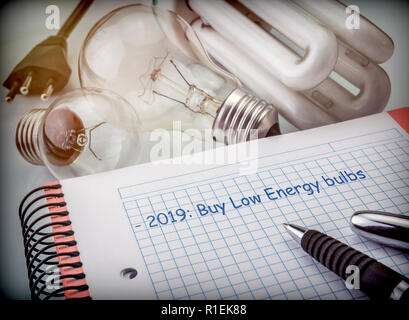 Objectives to save in the next year, reduce energy consumption, buy bulbs of low consumption, conceptual image Stock Photo