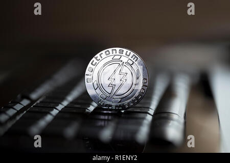 Electroneum cryptocurrency physical coin placed on the computer keyboard Stock Photo