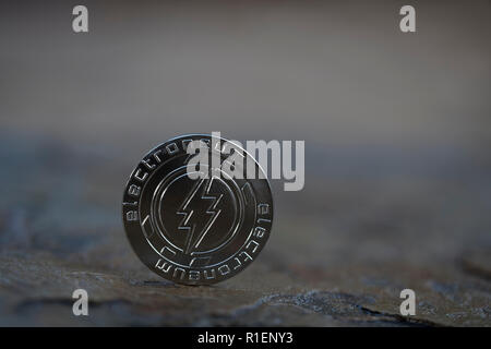 Electroneum cryptocurrency physical coin standing on stone floor Stock Photo