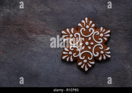 Gingerbread cookies snowflake on dark background, copyspace Stock Photo