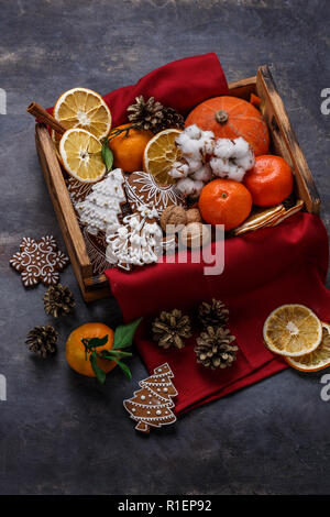 Christmas wooden box filled with gingerbread cookies, dry oranges, tangerines and nuts, copyspace Stock Photo