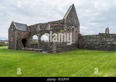 St Mary's Nunnery, Isle of Iona, Scotland, old building remains, on a cloudy day, surrounded by the green grass. Stock Photo