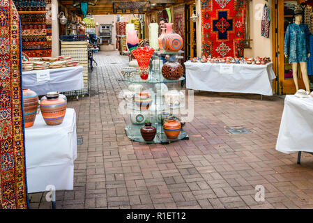 One of many outdoor arcade style shopping areas selling pots and rugs in historic downtown Santa Fe, NM Stock Photo