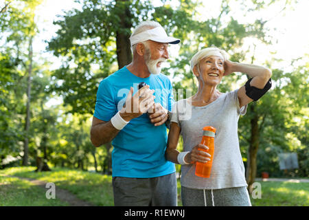 Mature couple jogging and running outdoors in nature Stock Photo