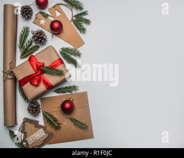 New Year or Christmas concept of gift wrapping, paper, envelopes, Christmas tree branches, on a white background, place for text flat lay Stock Photo