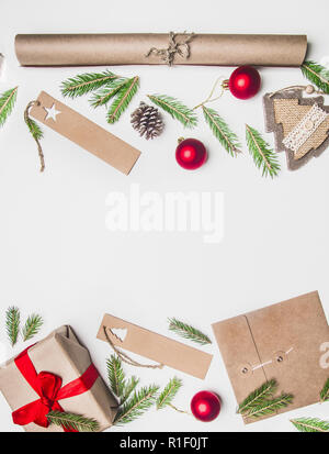 New Year or Christmas concept of gift wrapping, paper, envelopes, Christmas tree branches, on a white background, place for text flat lay Stock Photo