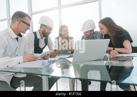 group of young architects and designers discussing a new project. Stock Photo