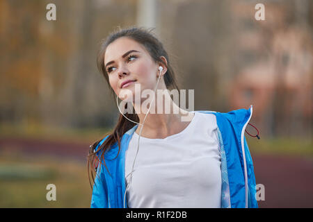 Beautiful girl listens to a player at the stadium. Stock Photo