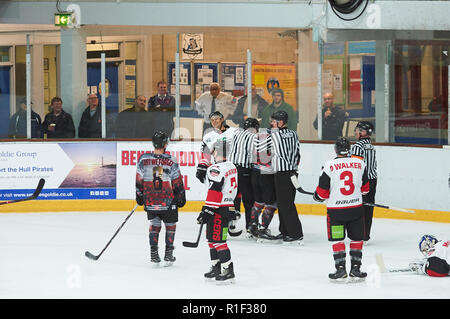 Referees breaking up a fight in an ice hockey match Stock Photo