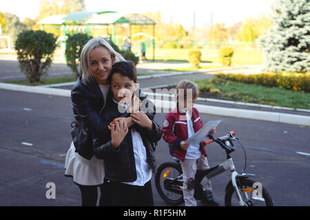 happy mother and son blowing soap bubbles on street Stock Photo