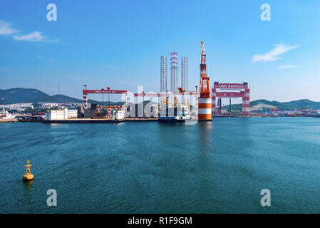 YANTAI, SHANDONG, CHINA - 21JUL2018: The CIMC Raffles Shipyard. To the right is Taisun, the largest gantry crane in the world with a lifting capacity  Stock Photo