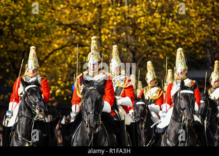 Life Guards of the Household Cavalry Mounted Regiment on horseback at the Lord Mayor's Show Parade, London, UK. Autumn leaves on tree. Fall colors Stock Photo