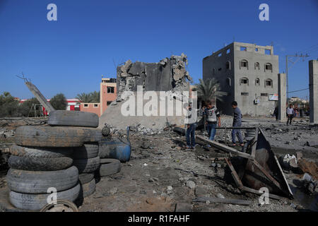 Palestinian children inspecting the effects of the Israeli shelling of the Makaniki workshop in Khan Younis. The israeli air force carried out air strike in the Southern Gaza strip area of Khan Younis on the night of 11 Nov causing damages to the building and human casualties. Stock Photo