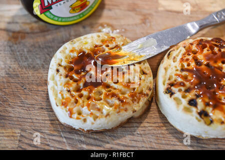 Toasted hot crumpets with butter and marmite  for breakfast Stock Photo
