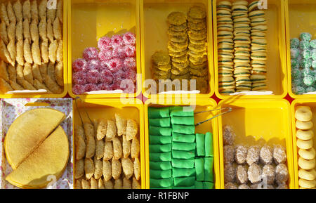 Variety of delicious and colorful Malaysian home cooked local cakes or 'kueh' sold at street market stall in Kota Kinabalu Sabah from top angle view w Stock Photo