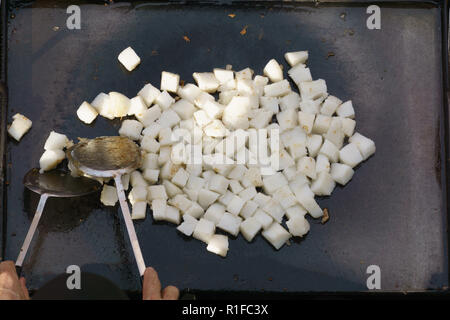 Chinese street chef cooking fried food called 'kueh lobah' a famous Chinese street food at Segama night market in Kota Kinabalu Sabah. Stock Photo