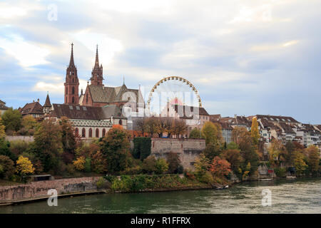 Basel Munster in the river Rhine, at the autumn fair with the ferris wheel in Switzerland
