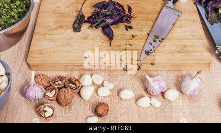 basil leaves and knife on a cutting board Stock Photo