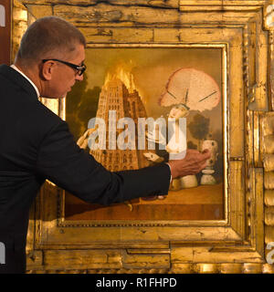 Prague, Czech Republic. 08th Nov, 2018. Czech Prime Minister Andrej Babis gave the painting Visionaries and Arsonists by Zdenek Janda to French President Emmanuel Macron on November 10, 2018, in Paris, France. Babis is attending the 100th celebrations of the end of World War One in Paris. The painting depicting the burning Tower of Babel is Babis's personal gift to Macron. Janda is Babis's friend. On the photo Babis presents the painting to journalists in Prague, Czech Republic, on November 8, 2018. Credit: Michal Krumphzanzl/CTK Photo/Alamy Live News Stock Photo