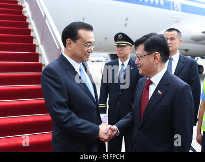 (181112) -- SINGAPORE, Nov. 12, 2018 (Xinhua) -- Chinese Premier Li Keqiang (L, front) arrives in Singapore, Nov. 12, 2018. Li arrived here Monday to start his first official visit to Singapore. During the visit, Li is also going to attend the 21st China-ASEAN (the Association of Southeast Asian Nations) (10+1) leaders' meeting, the 21st ASEAN-China, Japan and South Korea (10+3) leaders' meeting and the 13th East Asia Summit. (Xinhua/Zhang Ling) (gxn) Stock Photo