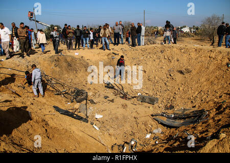 Palestinians inspecting the huge hole resulted from Israeli shelling at Khan Younis. The israeli air force carried out air strike in the Southern Gaza strip area of Khan Younis on the night of 11 Nov causing damages to the building and human casualties. Stock Photo