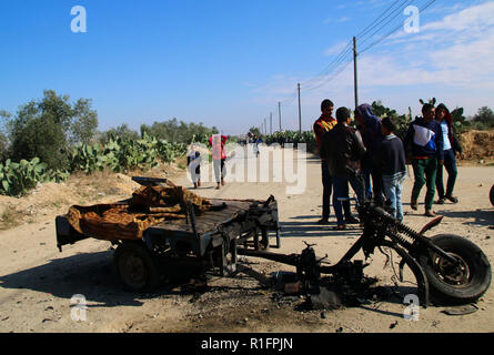 Khan Yunis, Gaza, Palestine. 12th Nov, 2018. Palestinian children gather around the wreckage of a vehicle which was destroyed by Israeli air strike.The israeli air force carried out air strike in the Southern Gaza strip area of Khan Younis on the night of 11 Nov causing damages to the building and human casualties. Credit: Ahmad Hasaballah/SOPA Images/ZUMA Wire/Alamy Live News Stock Photo