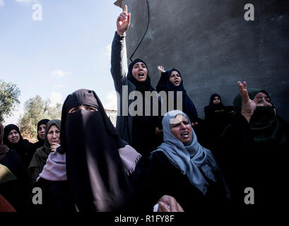 Gaza, Palestine. 12th Nov 2018. Relatives of Palestinian Mostafa Hassan Abu Odeh, who was killed in an Israeli air strike, mourn during his funeral, in Khan Younis. Credit: SOPA Images Limited/Alamy Live News Stock Photo